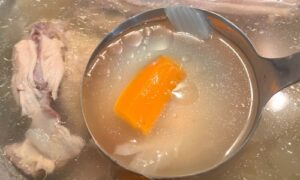 easy chicken bone broth in ladle